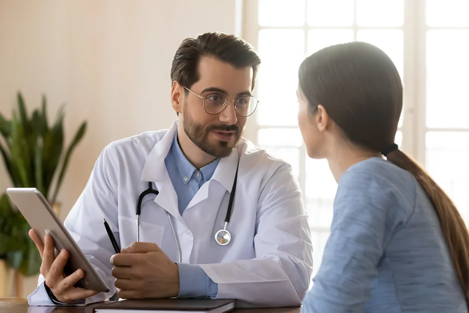 a doctor talking to his patient during consultation