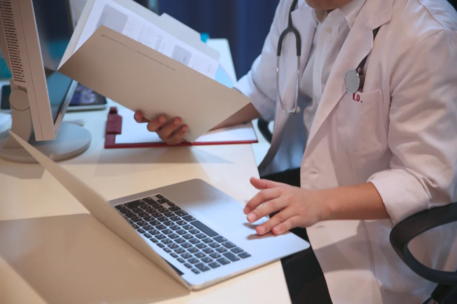 A Medical Doctor Checking Patient's Records Using EMR